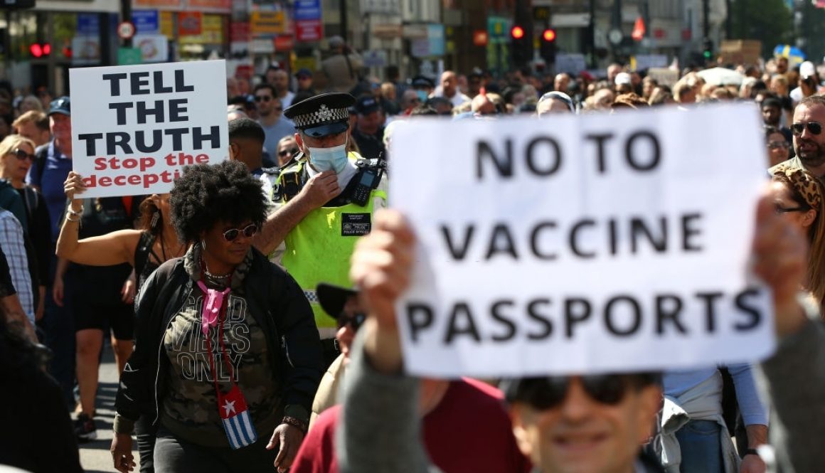 LONDON, ENGLAND - APRIL 24: A Met Police officer walks amongst protestors during a "Unite For Freedom" anti-lockdown demonstration held to protest against the use of vaccine passports in the United Kingdom, on April 24, 2021 in London, England. The proposed vaccine passports would enable members of the public to prove that they have received a COVID-19 vaccination, which many argue will allow major events to take place. Opposers of the scheme fear that the passports will result in discrimination against those who have not been vaccinated. (Photo by Hollie Adams/Getty Images)