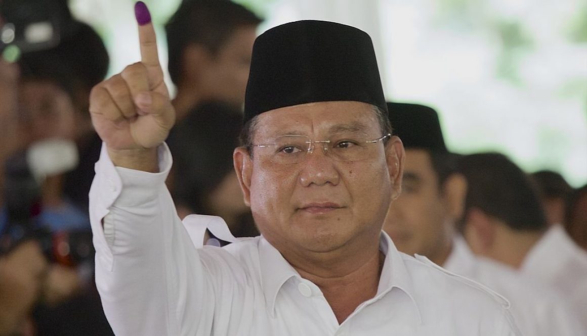 BOJONG KONENG INDONESIA - JULY 09: Indonesian presidential candidate Prabowo Subianto shows ink-stained finger after voting in his local polling station on July 9, 2014 in Bojong Koneng, Indonesia. Indonesians went to the polls today to vote in the country's presidential election being contested by two candidates - Prabowo Subianto, a former military General and Joko Widodo, the former governor of Jakarta. (Photo by Ed Wray/Getty Images)