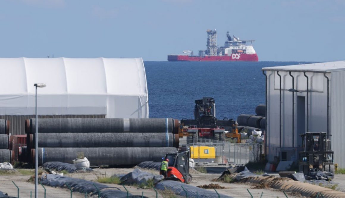 SASSNITZ, GERMANY - AUGUST 04: A ship of DOF Subsea, a Norwegian company that does subsea work for oil and gas companies, stands offshore next to pipe sections for the Nord Stream 2 pipeline stacked at Mukran Port on Rügen Island on August 04, 2021 in Sassnitz, Germany. Mukran Port is the main German operating base for supplying pipe sections to the Nord Stream 2 gas pipeline, a dual line pipeline that runs along the Baltic Sea floor and will transport natural gas from Russia to Germany. The first line was completed earlier this year and the second line is under construction.The project has been a source of international controversy as it has drawn opposition from the United States, Poland and Ukraine. (Photo by Sean Gallup/Getty Images)
