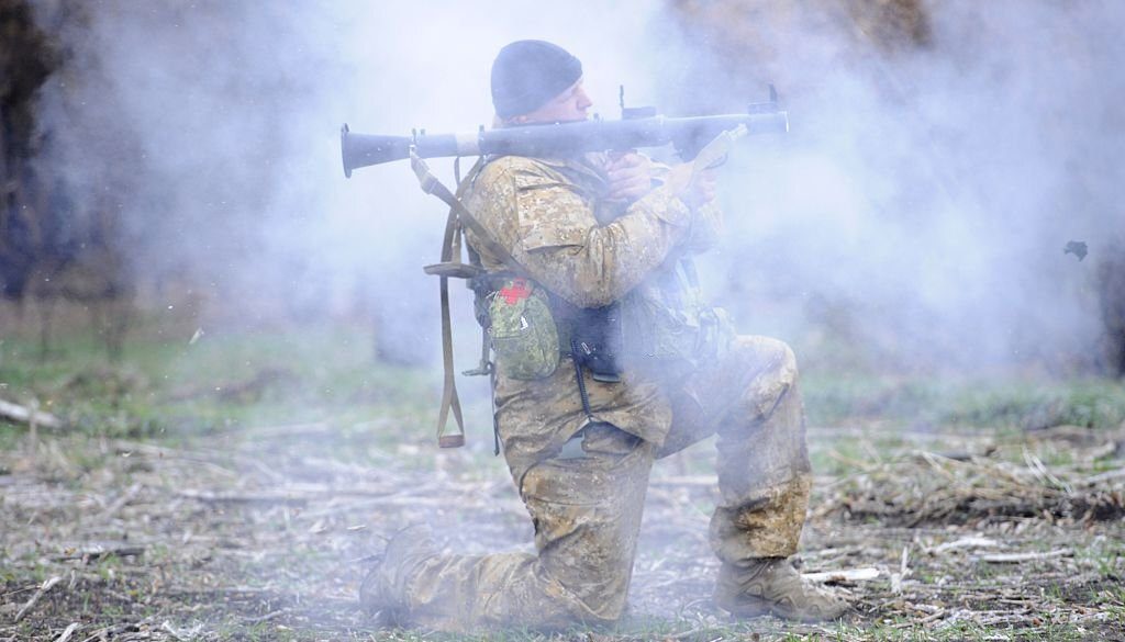 A Ukrainian soldier fires towards the position of pro-Russian militants near Bugas village, Donetsk region, on October 24, 2014. Ukraine wraps up campaigning Friday for a weekend vote that will dramatically reshape parliament after a year of upheavals, as the deadly conflict with pro-Russian rebels drags on into its seventh month. AFP PHOTO/ ALEXANDER KHUDOTEPLY (Photo credit should read Alexander KHUDOTEPLY/AFP via Getty Images)