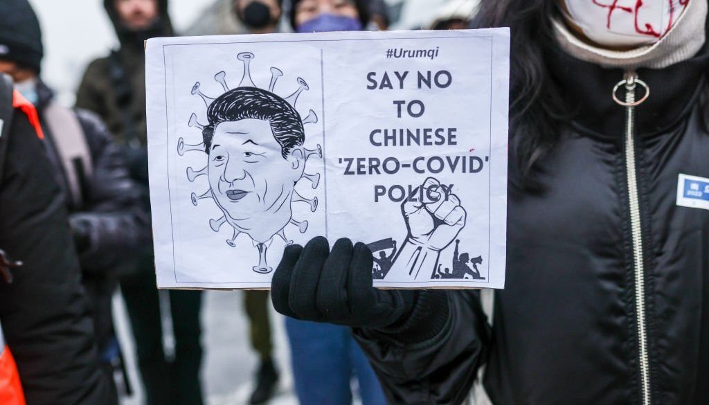 BERLIN, GERMANY - DECEMBER 03: A demonstrator holds a banner with an image of Chinese President Xi Jinping, during a protest in front of the Chinese Embassy in solidarity with protesters in China on December 3, 2022 in Berlin, Germany. Protests have been occurring in cities across China recently over the country's ongoing intense Covid lockdowns. A common feature has included protesters holding up blank sheets of A4 paper to symbolize China's heavy-handed enforcement against free speech. (Photo by Omer Messinger/Getty Images)