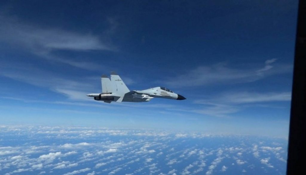 A Chinese Navy J-11 fighter jet is recorded flying close to a U.S. Air Force RC-135 aircraft in international airspace over the South China Sea, according to the U.S. military, in a still image from video taken Dec. 21. (U.S. INDO-PACIFIC COMMAND / VIA REUTERS)