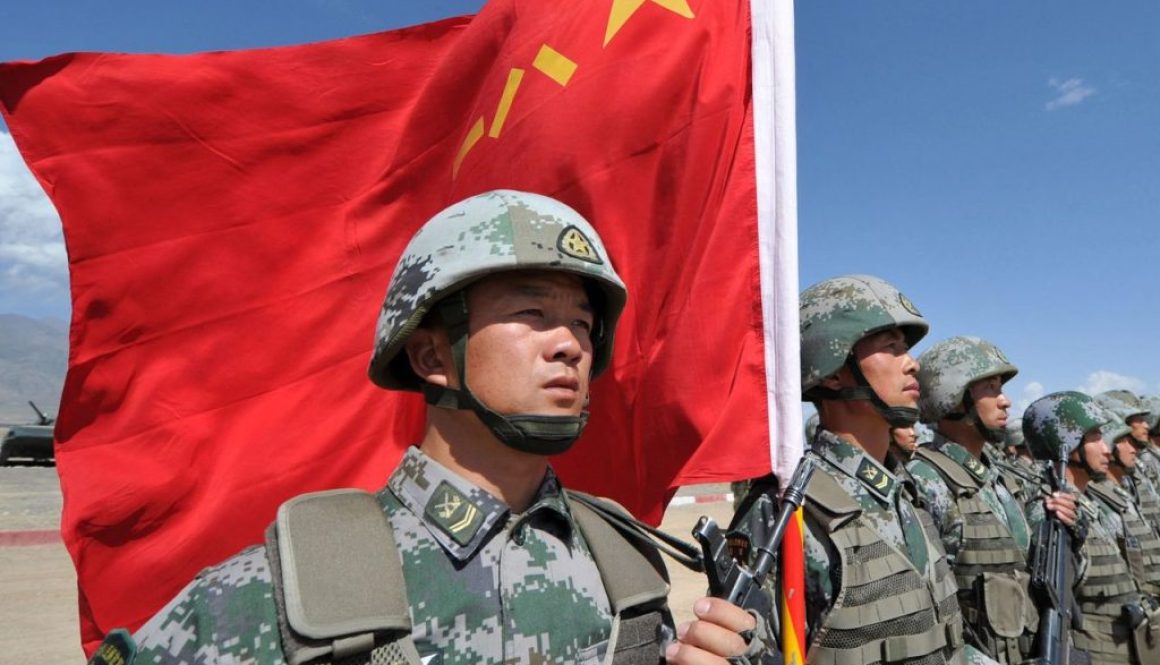 A Chinese soldier held a flag during joint military exercises in Kyrgyzstan in 2016. VYACHESLAV OSELEDKO/AFP/GETTY IMAGES