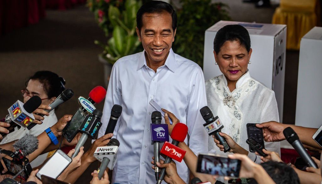 JAKARTA, INDONESIA - APRIL 17: Indonesian President Joko Widodo and his wife Iriana speak to journalists after casting his ballot at a polling station on April 17, 2019 in Jakarta, Indonesia. Indonesia's general elections pitting Widodo against Prabowo who he defeated in the last election in 2014. (Photo by Ulet Ifansasti/Getty Images)