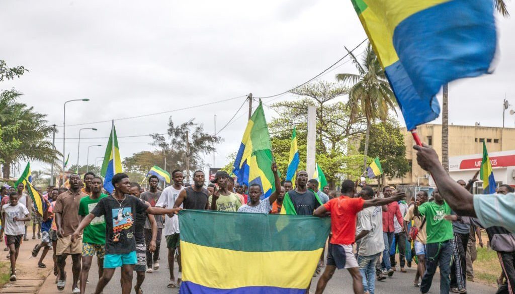 Gabonese people rejoicing in a street in Port-Gentil (economic capital), on August 30, 2023 after the announcement of the Coup d'Etat perpetrated by the Gabonese Defense and Security Forces. President Ali Bongo Ondimba was deposed a few minutes after the announcement of his victory in the presidential elections of August 26, 2023. (Photo by: Desirey Minkoh/Afrikimages Agency/Universal Images Group via Getty Images)