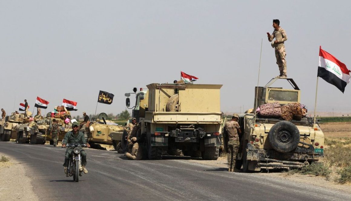 Iraqi forces rest near Kirkuk as they head for Kurdish peshmerga positions