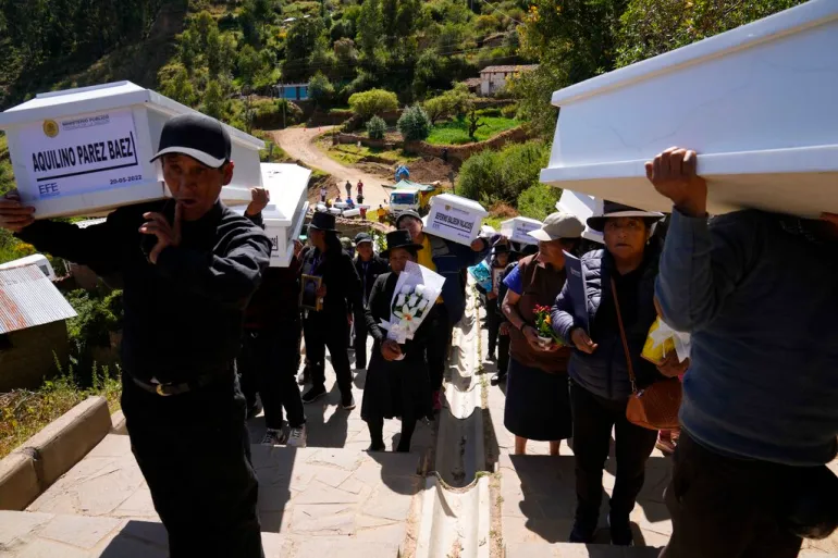 People carry the remains of relatives killed during the Maoist-inspired armed uprising to the cemetery in Accomarca, Peru, on May 20, 2022 [File: Martin Mejia/AP Photo]